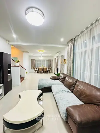 Spacious modern living room with elegant dining area and stylish furniture