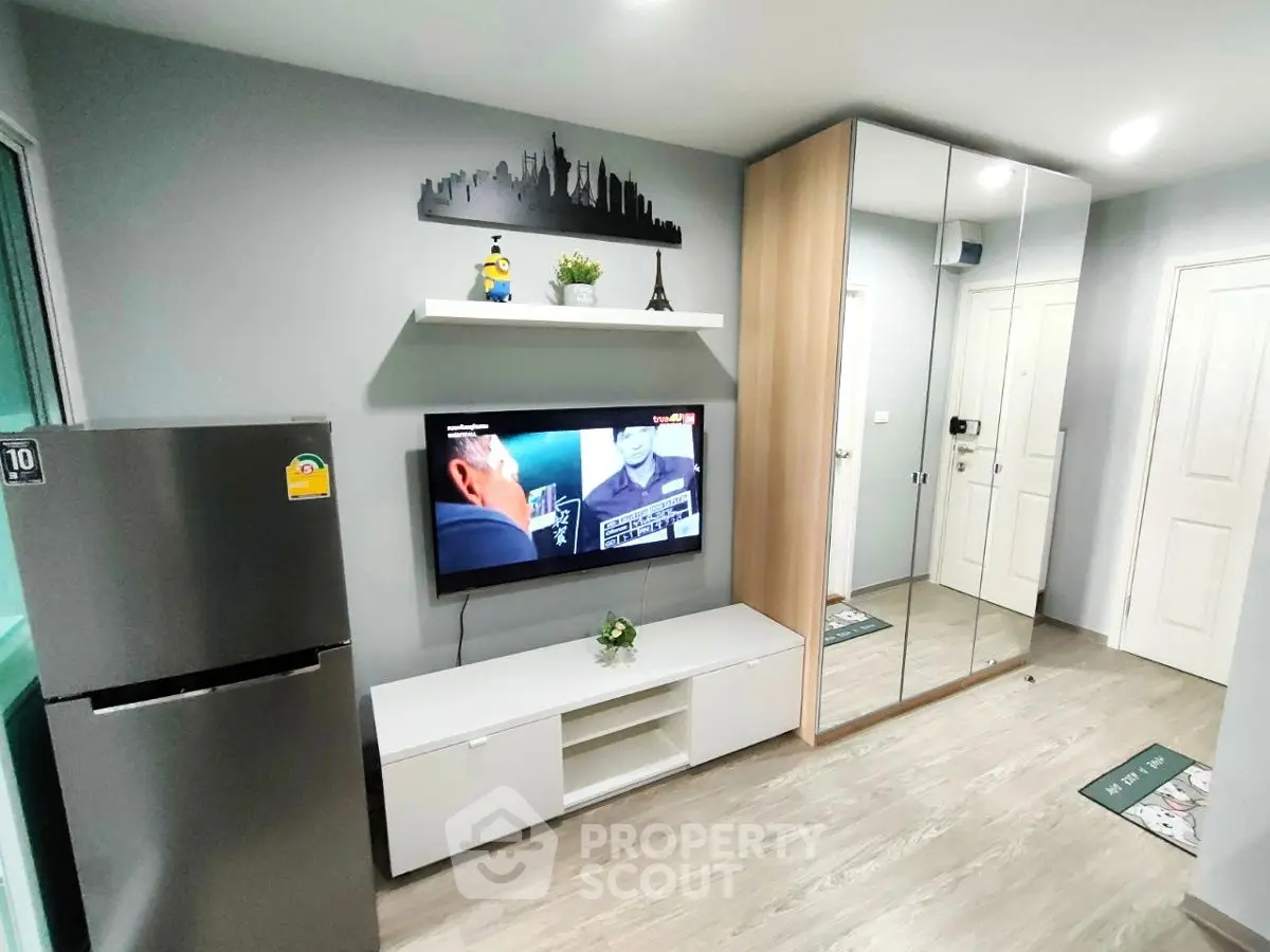 Modern living room with mirrored wardrobe and sleek TV setup