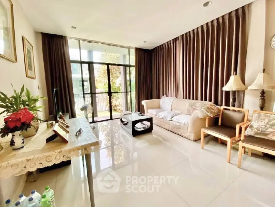 Spacious living room with elegant decor and large windows for natural light