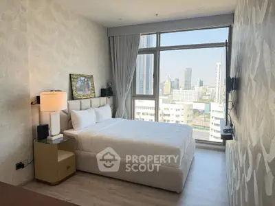 Luxurious bedroom with stunning city view and modern decor in high-rise apartment.
