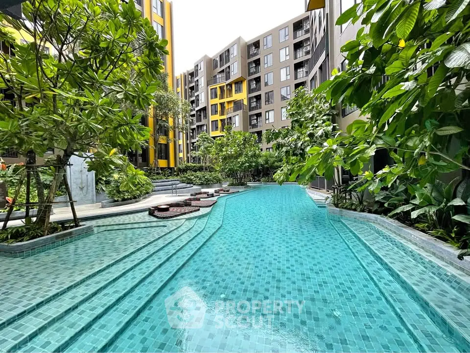 Luxurious apartment complex with stunning pool and lush greenery
