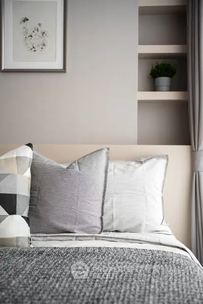 Cozy bedroom with stylish decor and modern shelving, perfect for relaxation and comfort.