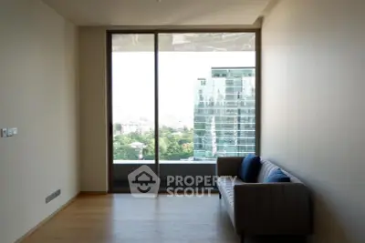 Modern living room with large window offering stunning city view and cozy sofa.