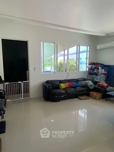 Spacious living room with modern decor and large windows for natural light.