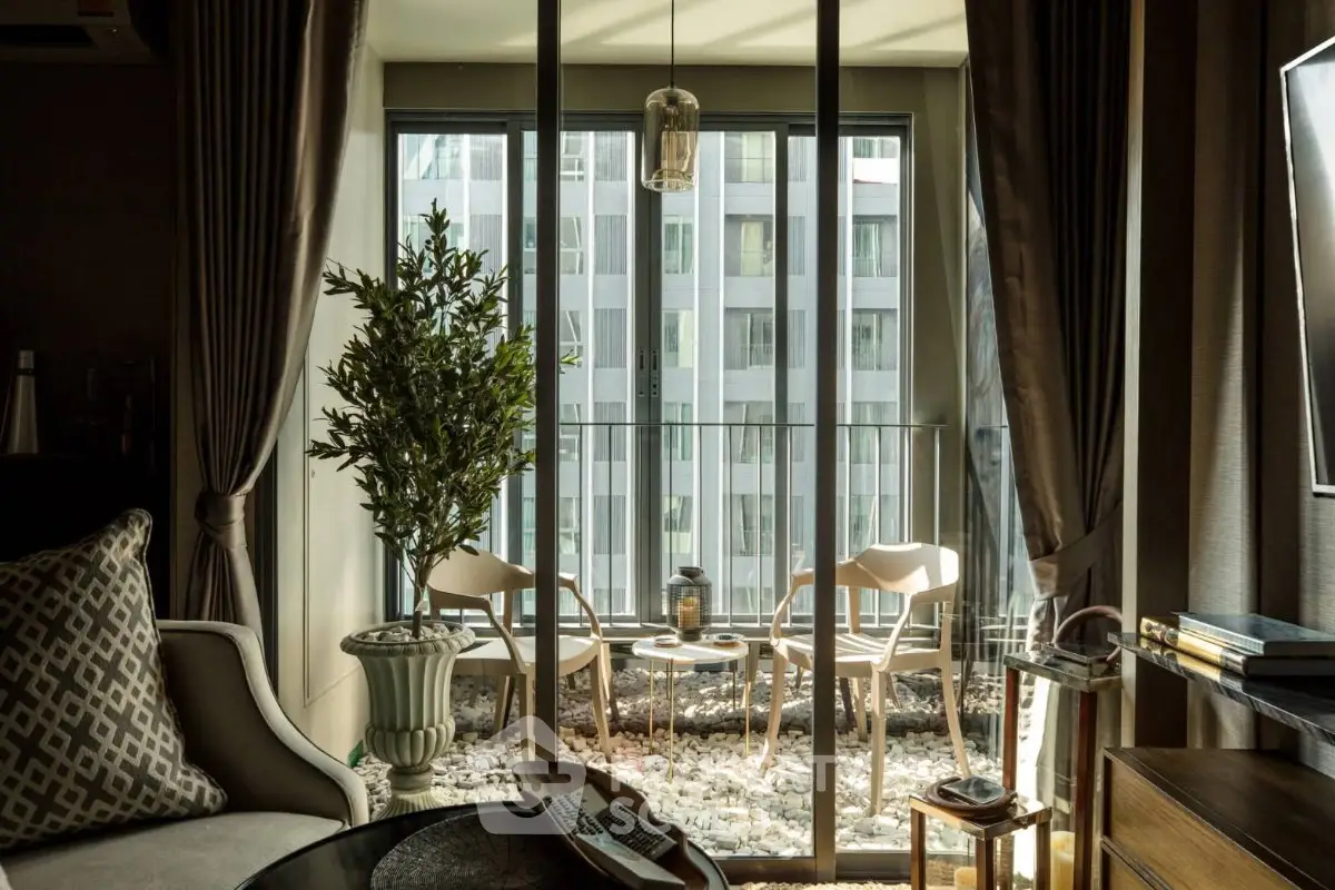 Stylish living room with floor-to-ceiling windows and cozy balcony view