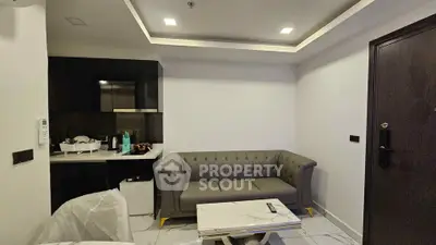 Modern living room with stylish sofa and sleek kitchen area