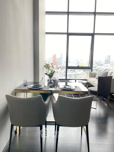 Modern living room with dining area and stunning city view through large windows.