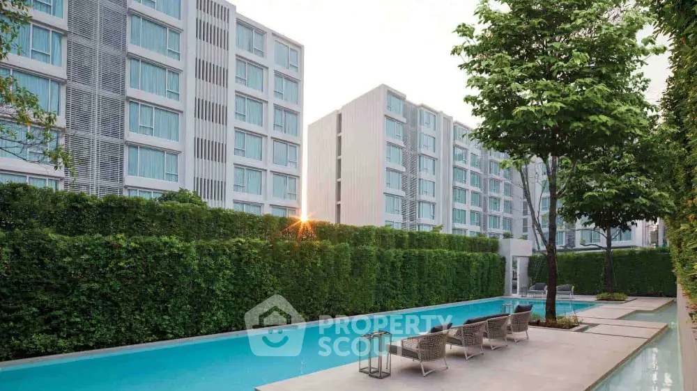 Modern apartment complex with pool and lush greenery, perfect for urban living.