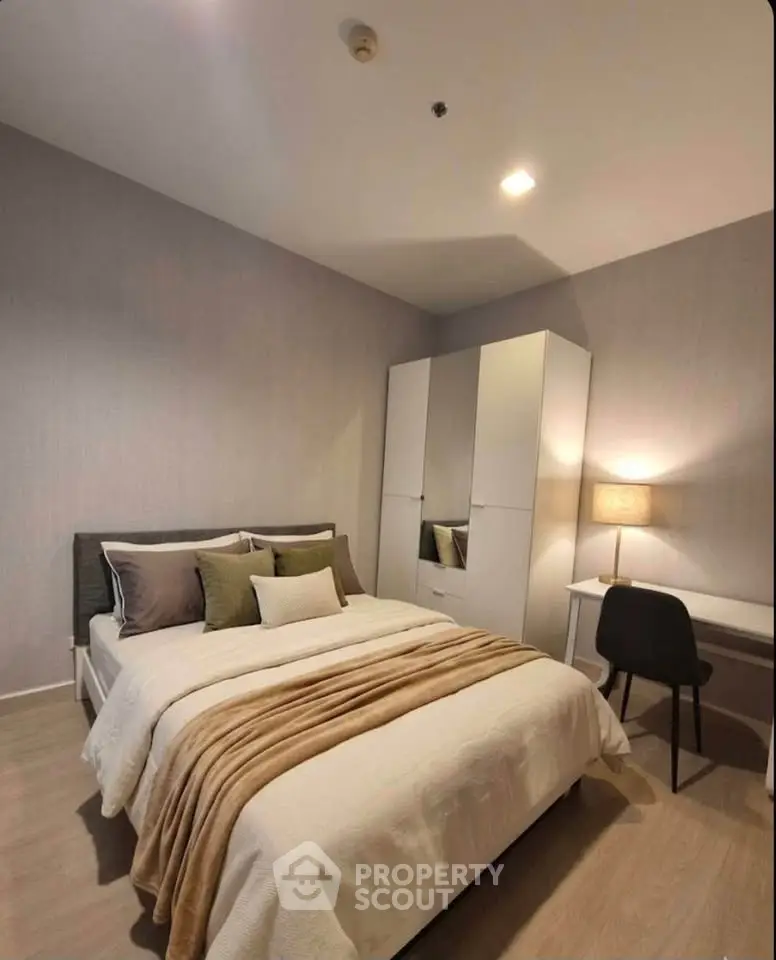 Cozy modern bedroom with stylish decor and ample storage space