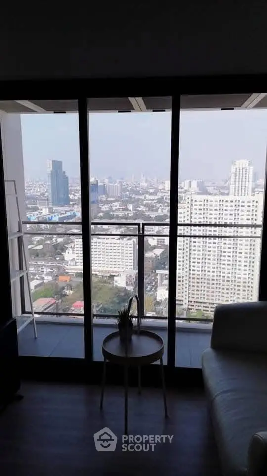 Stunning city view from a modern apartment balcony with sleek interior design.