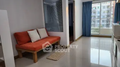Modern living room with orange sofa and large window view in urban apartment