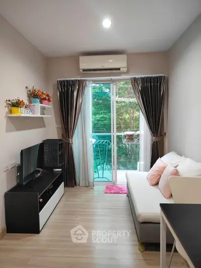 Cozy living room with modern decor and balcony view, perfect for relaxation and entertainment.