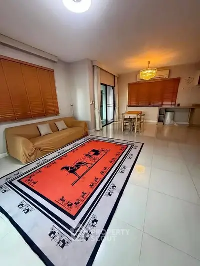 Spacious living room with elegant decor and large windows for natural light.