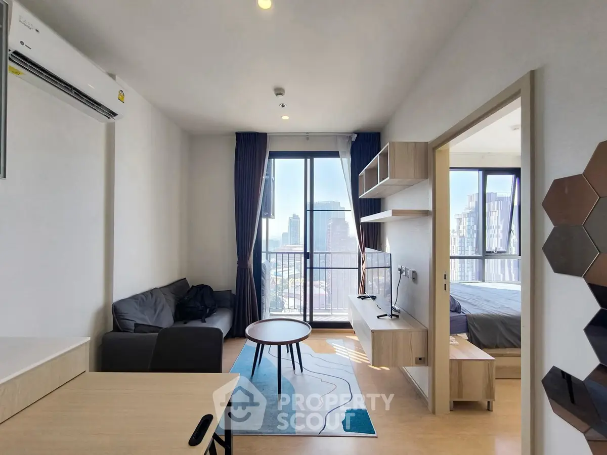 Modern living room with city view, featuring sleek furniture and open layout design.