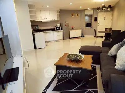 Spacious open-plan living room with modern kitchen and cozy seating area