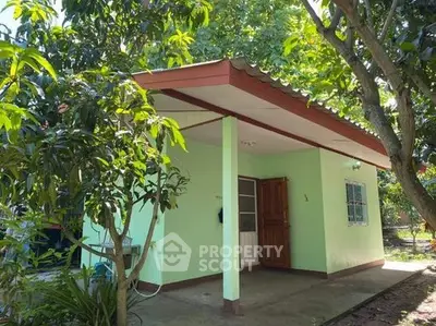 Charming small green house with lush garden and inviting entrance