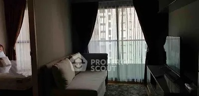 Cozy living room with modern sofa and large window offering natural light in urban apartment.