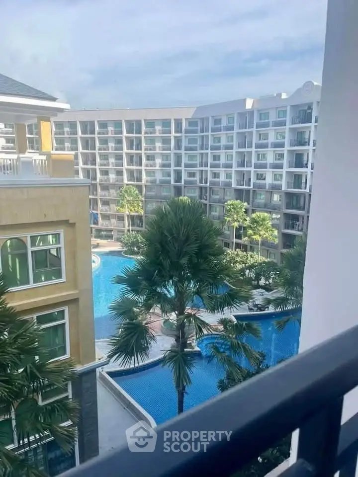 Luxurious apartment complex with stunning pool view and lush greenery, perfect for modern living.