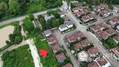 Aerial view of a residential neighborhood with multiple houses and greenery.