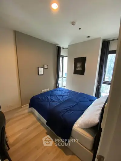 Cozy modern bedroom with city view and stylish decor