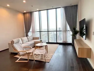 Spacious modern living room with floor-to-ceiling windows and city view