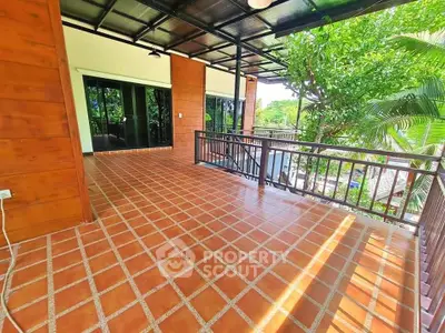 Spacious balcony with terracotta tiles and lush green views