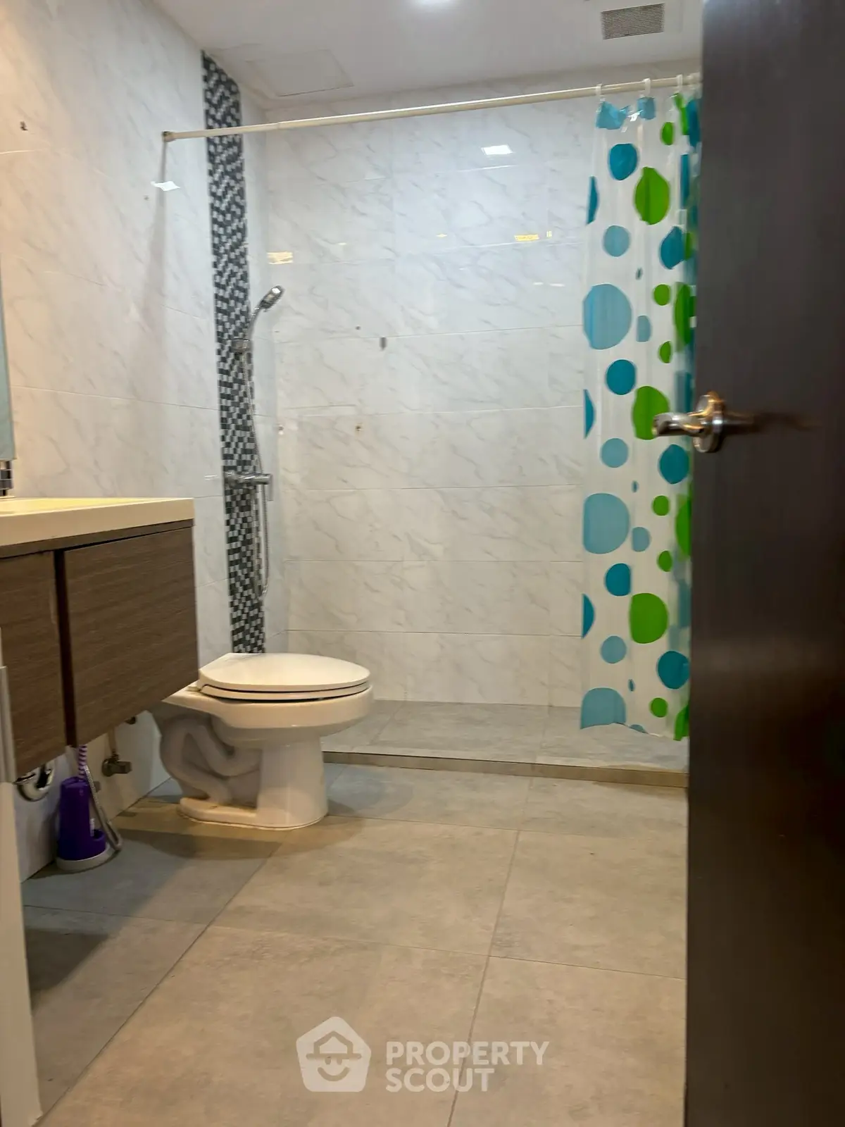 Modern bathroom with sleek fixtures and colorful shower curtain