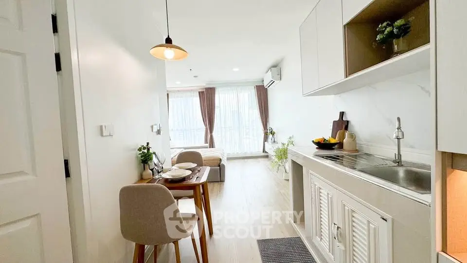 Modern open-plan living room and kitchen with natural light and stylish decor