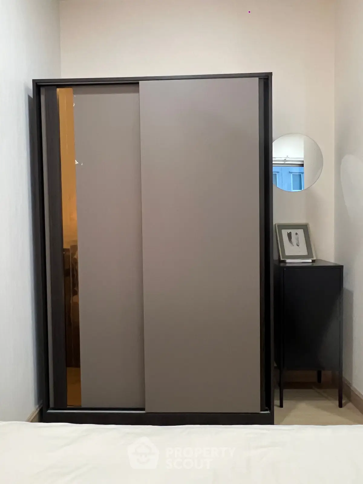 Modern bedroom with sleek sliding wardrobe and minimalist decor