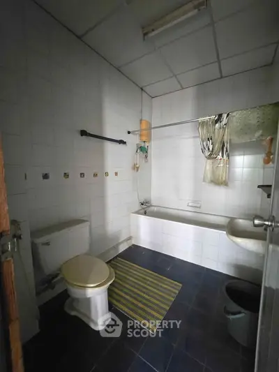 Spacious bathroom with bathtub and modern fixtures in a cozy home setting.