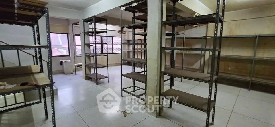 Spacious storage room with metal shelving units and tiled flooring, ideal for organizing and maximizing space.