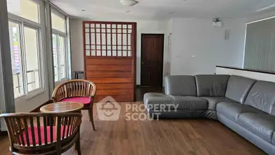 Spacious living room with modern furniture and wooden flooring