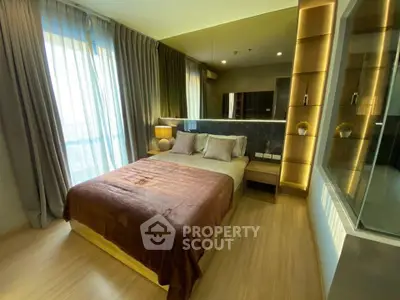 Luxurious bedroom with modern decor and large window offering natural light.
