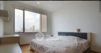 Spacious bedroom with city view and natural light in modern apartment