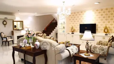 Luxurious living room with elegant decor, plush sofas, and a stylish chandelier, perfect for sophisticated gatherings.