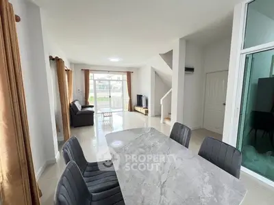 Spacious modern living room with dining area and natural light