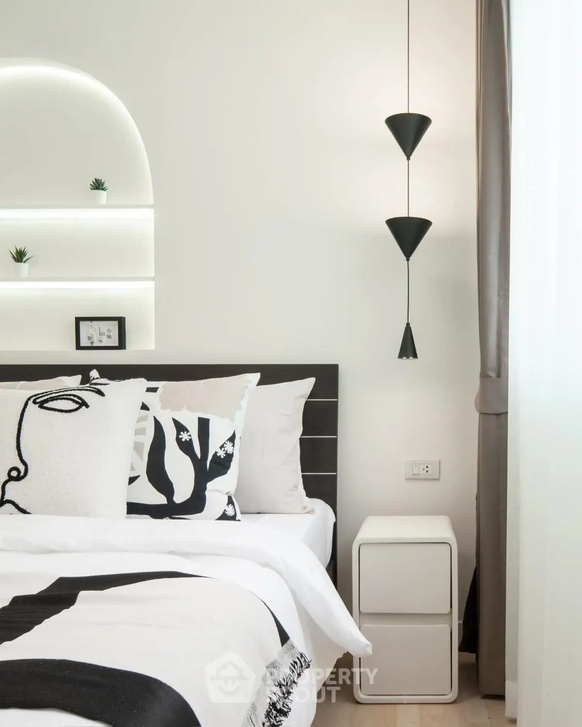 Modern bedroom with stylish decor and unique lighting fixtures