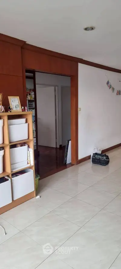 Spacious interior with tiled floors and wooden accents, ideal for versatile living space.