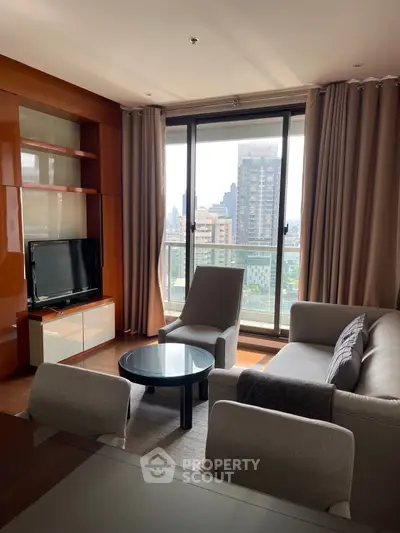 Modern living room with city view, featuring sleek furniture and large windows.