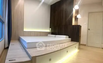 Modern bedroom with elevated platform bed and ambient lighting
