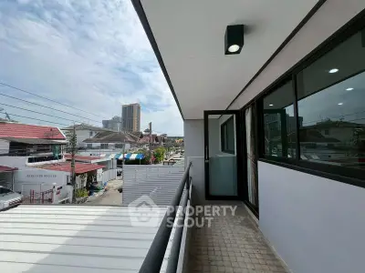 Modern balcony with city view, perfect for relaxation and enjoying urban living.