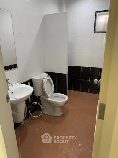 Modern bathroom with sleek fixtures and tiled flooring, ideal for contemporary living.