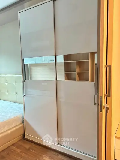 Modern bedroom with sleek sliding wardrobe and cozy bed