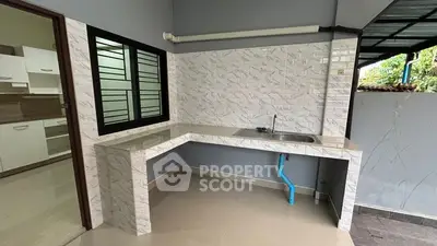 Modern kitchen with sleek countertops and tiled backsplash