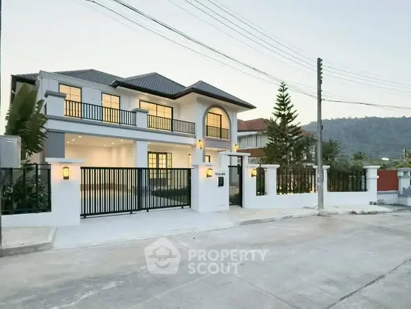 Stunning modern two-story house with elegant facade and spacious driveway in serene neighborhood.
