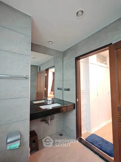 Modern bathroom with sleek design and large mirror in a contemporary home.