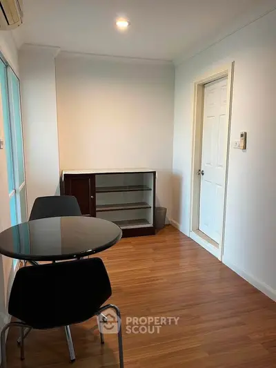 Cozy study room with modern furniture and wooden flooring, perfect for productivity and comfort.