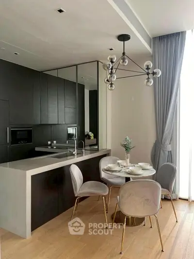 Modern kitchen with sleek black cabinets and stylish dining area