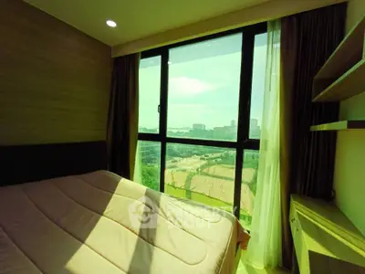 Bright bedroom with large window offering a stunning city view, featuring cozy bedding and modern furnishings.