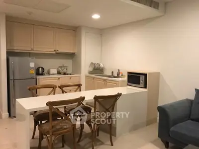 Charming kitchen with dining area, featuring modern appliances and cozy seating, perfect for intimate gatherings.